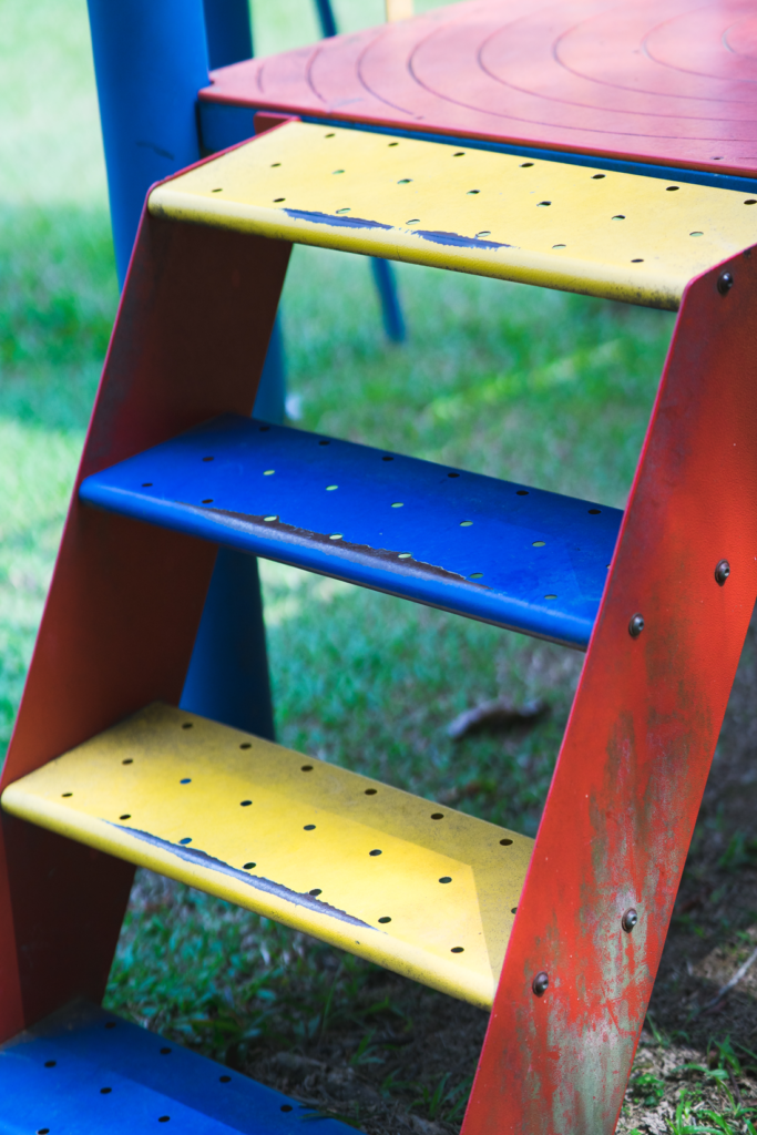 old and worn powder coated playground stairs